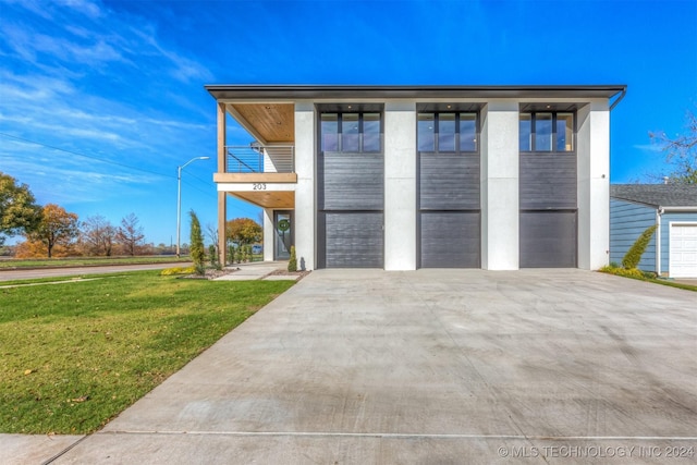 203 E 45th Ct, Tulsa, OK 74105 - garage featuring concrete driveway