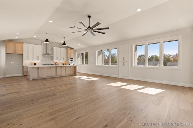 203 E 45th Ct, Tulsa, OK 74105 - unfurnished living room featuring vaulted ceiling, a ceiling fan, recessed lighting, and light wood-style flooring