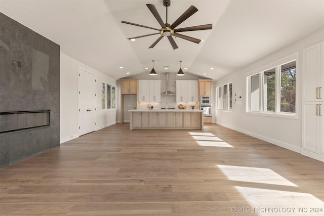 203 E 45th Ct, Tulsa, OK 74105 - unfurnished living room with a ceiling fan, light wood-type flooring, vaulted ceiling, and recessed lighting