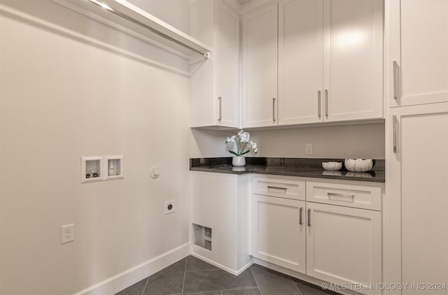 203 E 45th Ct, Tulsa, OK 74105 - laundry area with cabinet space, hookup for an electric dryer, dark tile patterned flooring, and washer hookup