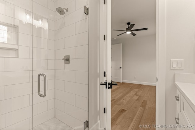 203 E 45th Ct, Tulsa, OK 74105 - bathroom featuring a shower stall, vanity, and wood finished floors