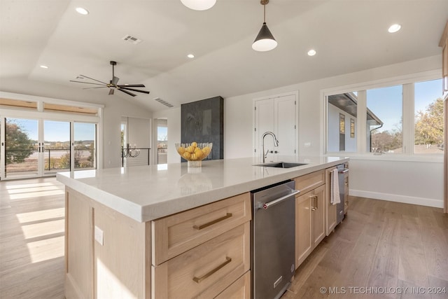 kitchen with light brown cabinetry, a center island with sink, lofted ceiling, and sink