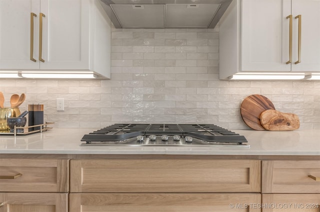 203 E 45th Ct, Tulsa, OK 74105 - kitchen featuring range hood, stainless steel gas cooktop, light countertops, and tasteful backsplash