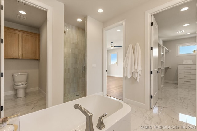 bathroom with ceiling fan, toilet, and plus walk in shower