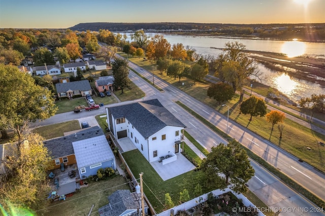 aerial view at dusk with a water view