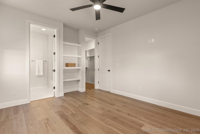 unfurnished bedroom featuring light hardwood / wood-style floors, ensuite bath, and ceiling fan