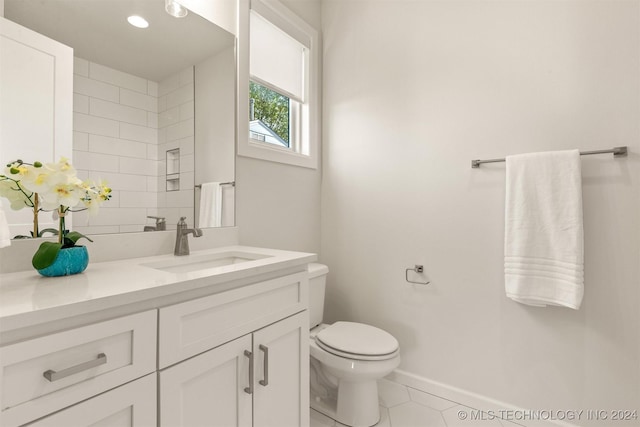 bathroom featuring tile patterned flooring, vanity, and toilet