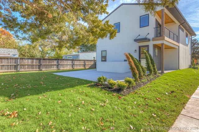 view of yard with a patio area and a balcony