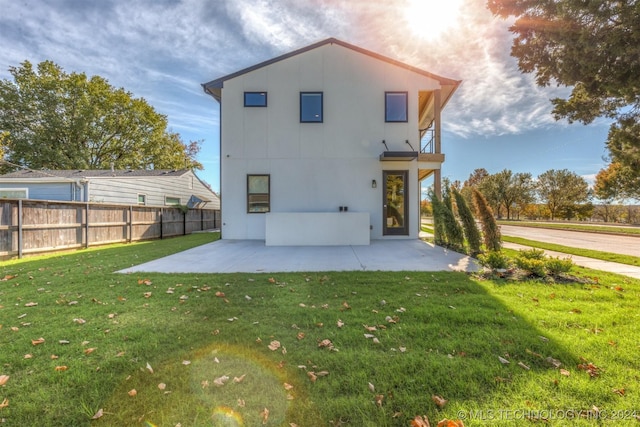 rear view of property with a yard and a patio