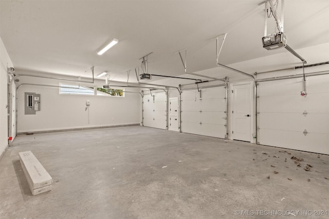 garage featuring electric panel and a garage door opener