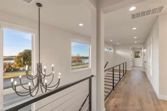 203 E 45th Ct, Tulsa, OK 74105 - corridor with an upstairs landing, recessed lighting, light wood-style floors, and a chandelier
