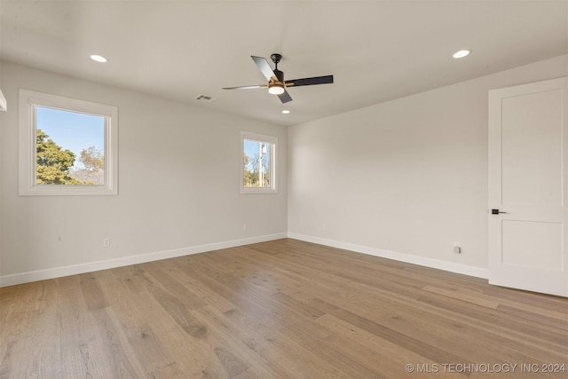 empty room featuring light wood-type flooring and ceiling fan