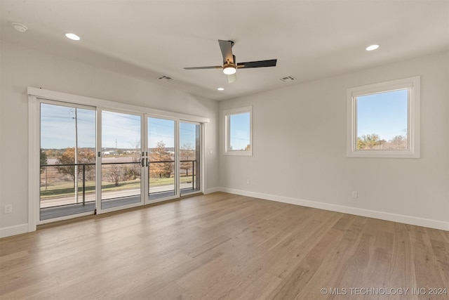 unfurnished room with ceiling fan and light wood-type flooring