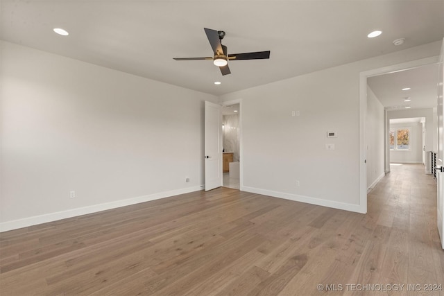 empty room with light hardwood / wood-style floors and ceiling fan