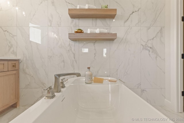 bathroom with a bathtub and vanity