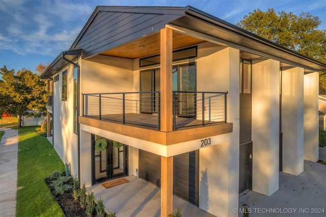 203 E 45th Ct, Tulsa, OK 74105 - view of property exterior featuring a balcony and stucco siding
