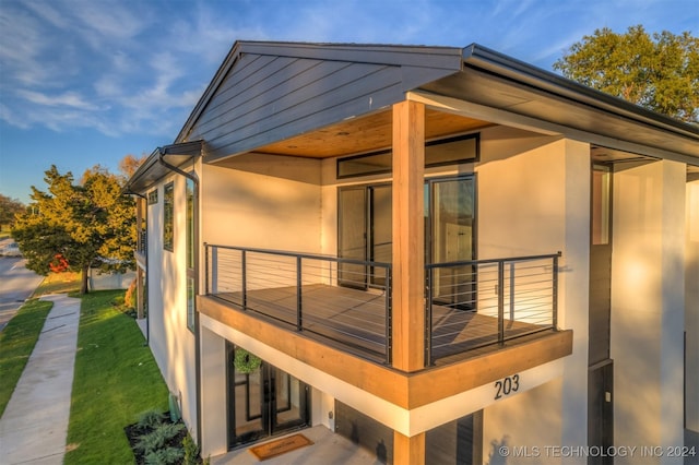 203 E 45th Ct, Tulsa, OK 74105 - view of home's exterior with a balcony and stucco siding