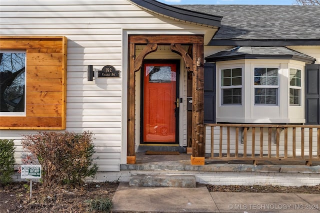 view of exterior entry featuring covered porch