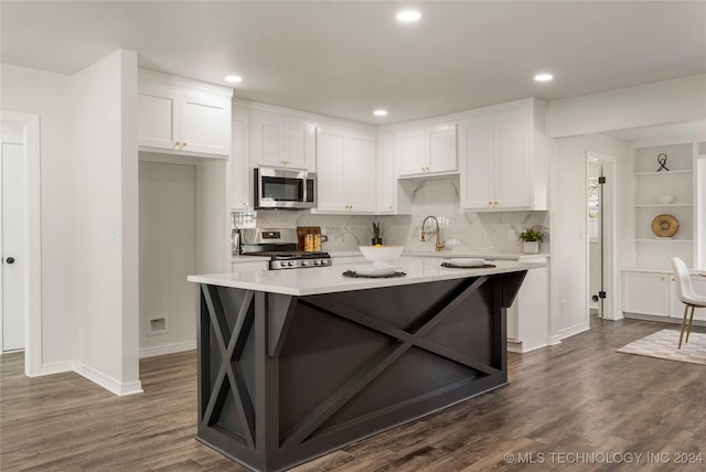 kitchen with white cabinets, backsplash, dark hardwood / wood-style flooring, and stainless steel appliances