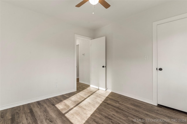 unfurnished room featuring dark hardwood / wood-style floors and ceiling fan