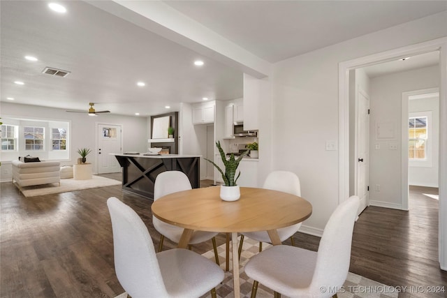 dining space featuring dark hardwood / wood-style floors and ceiling fan