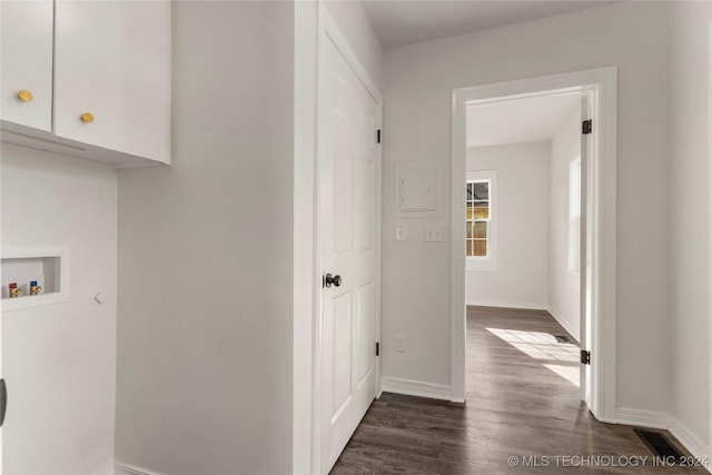 washroom with hookup for a washing machine, cabinets, and dark hardwood / wood-style floors