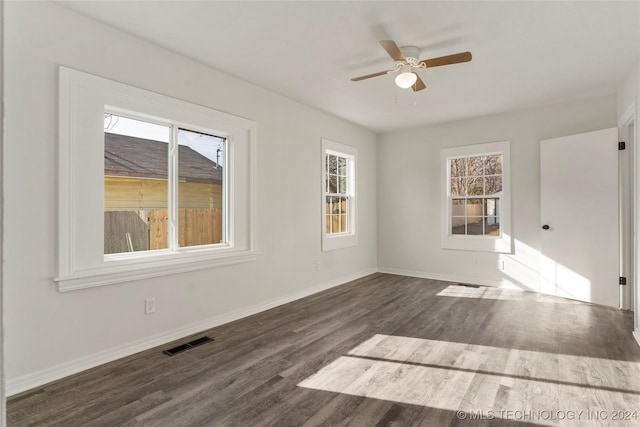 spare room with ceiling fan and dark hardwood / wood-style floors