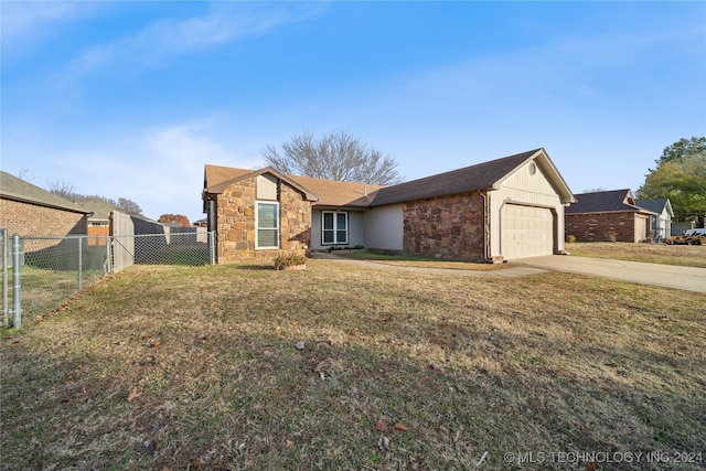 ranch-style home with a garage and a front lawn