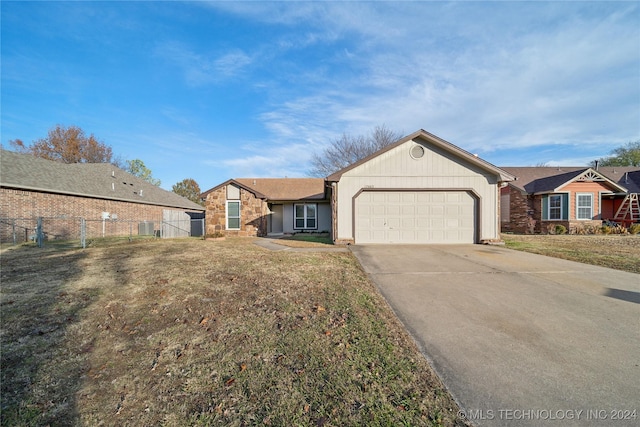 ranch-style house with a front yard and a garage