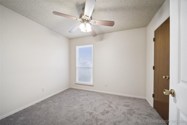 carpeted empty room with a textured ceiling and ceiling fan