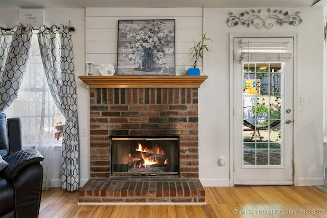 details featuring hardwood / wood-style floors and a fireplace