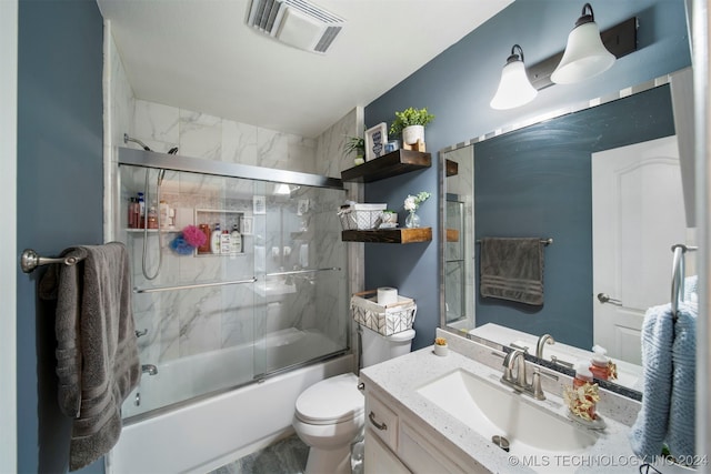 full bathroom featuring shower / bath combination with glass door, vanity, and toilet