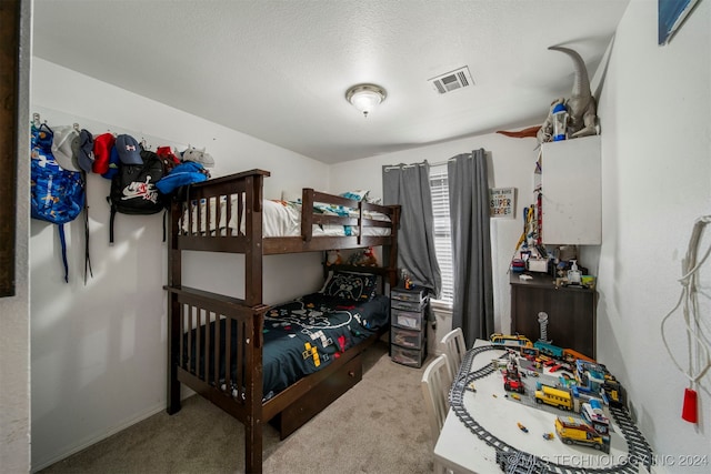 carpeted bedroom with a textured ceiling