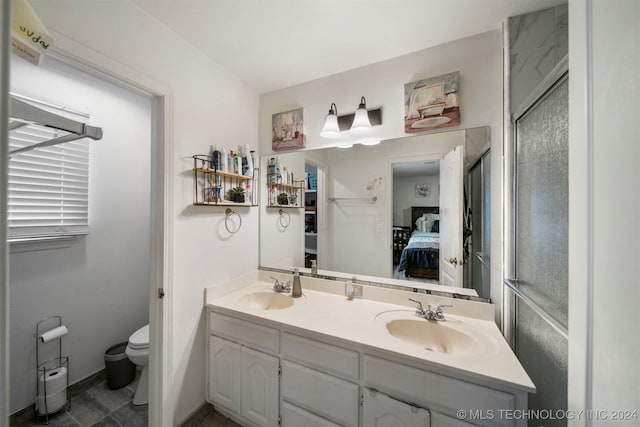 bathroom with vanity, toilet, and an enclosed shower