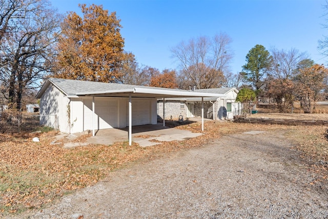 view of property exterior with a carport and a garage