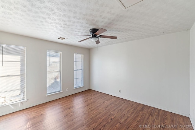 unfurnished room with wood-type flooring, a textured ceiling, and ceiling fan