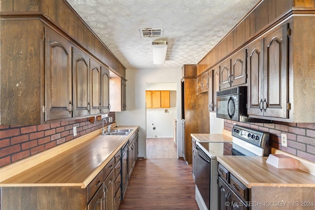 kitchen with decorative backsplash, a textured ceiling, dark wood-type flooring, sink, and stainless steel electric range