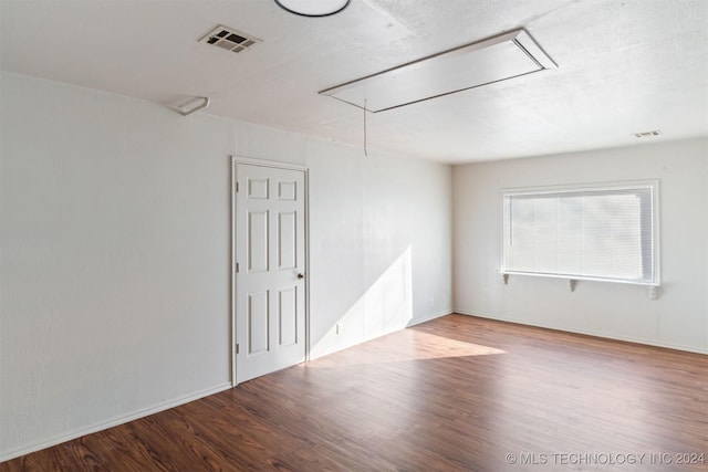 unfurnished room featuring hardwood / wood-style flooring