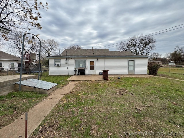 back of house featuring a patio area and a yard