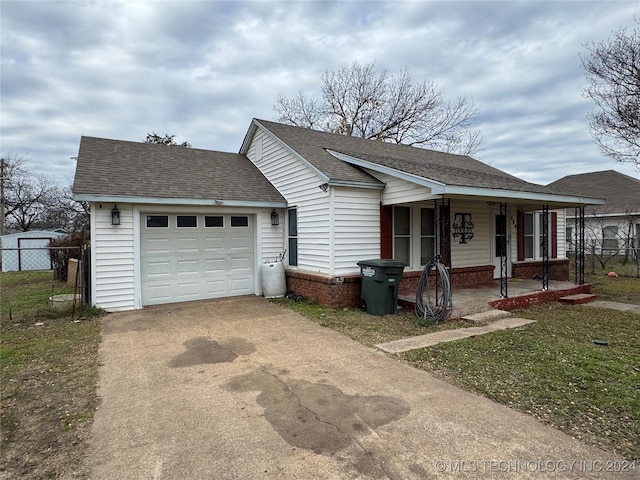 ranch-style house with a porch, a garage, and a front yard