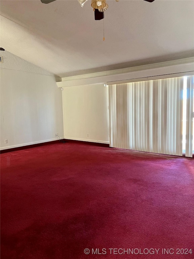 empty room with ceiling fan, carpet floors, and a textured ceiling