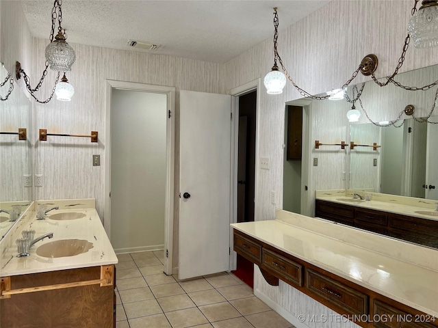 bathroom featuring tile patterned floors, vanity, and a textured ceiling