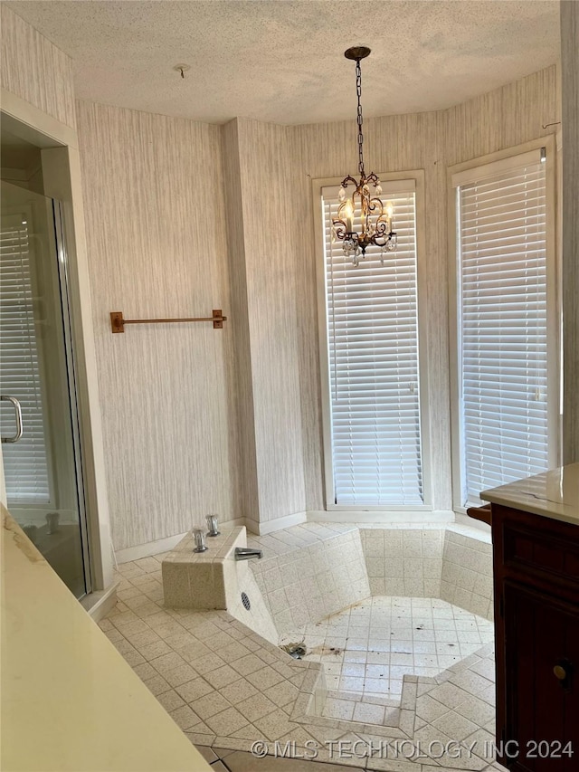 bathroom featuring vanity, a textured ceiling, and an inviting chandelier