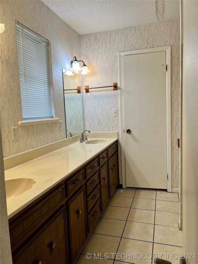 bathroom featuring vanity, a textured ceiling, and tile patterned floors