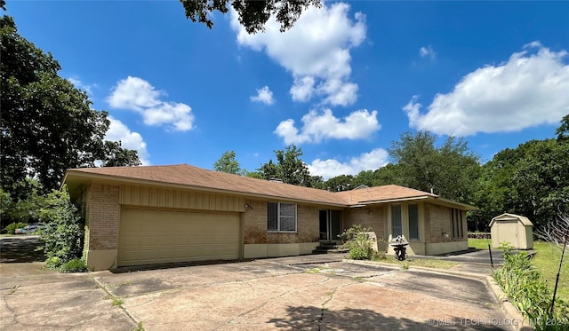 ranch-style home featuring a storage shed and a garage