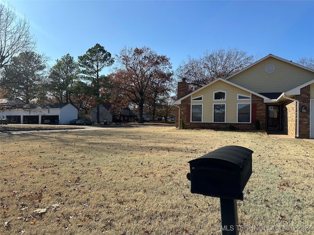 view of side of home with a lawn