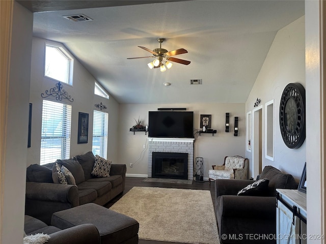 living room featuring ceiling fan, a brick fireplace, hardwood / wood-style floors, and lofted ceiling