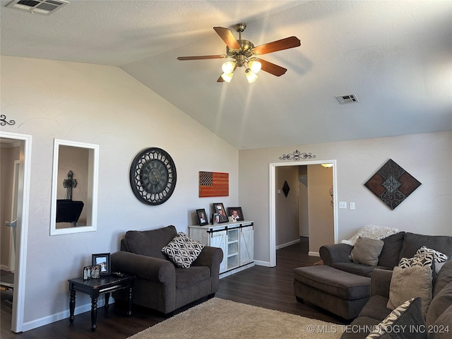 living room with a textured ceiling, vaulted ceiling, ceiling fan, and dark hardwood / wood-style flooring