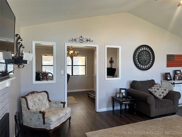 living room with dark hardwood / wood-style floors, vaulted ceiling, and a notable chandelier