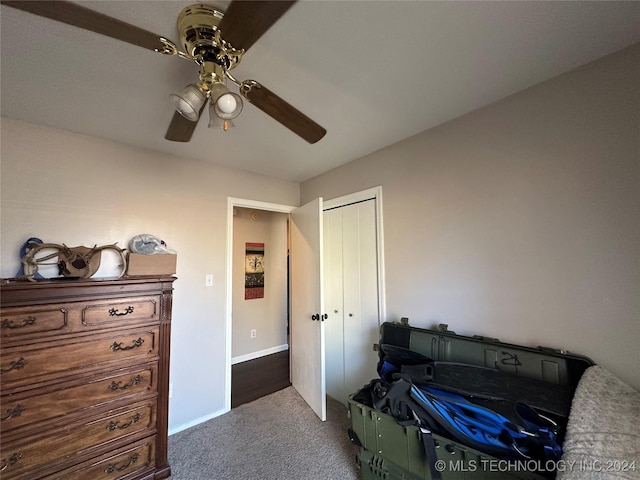 carpeted bedroom with ceiling fan and a closet